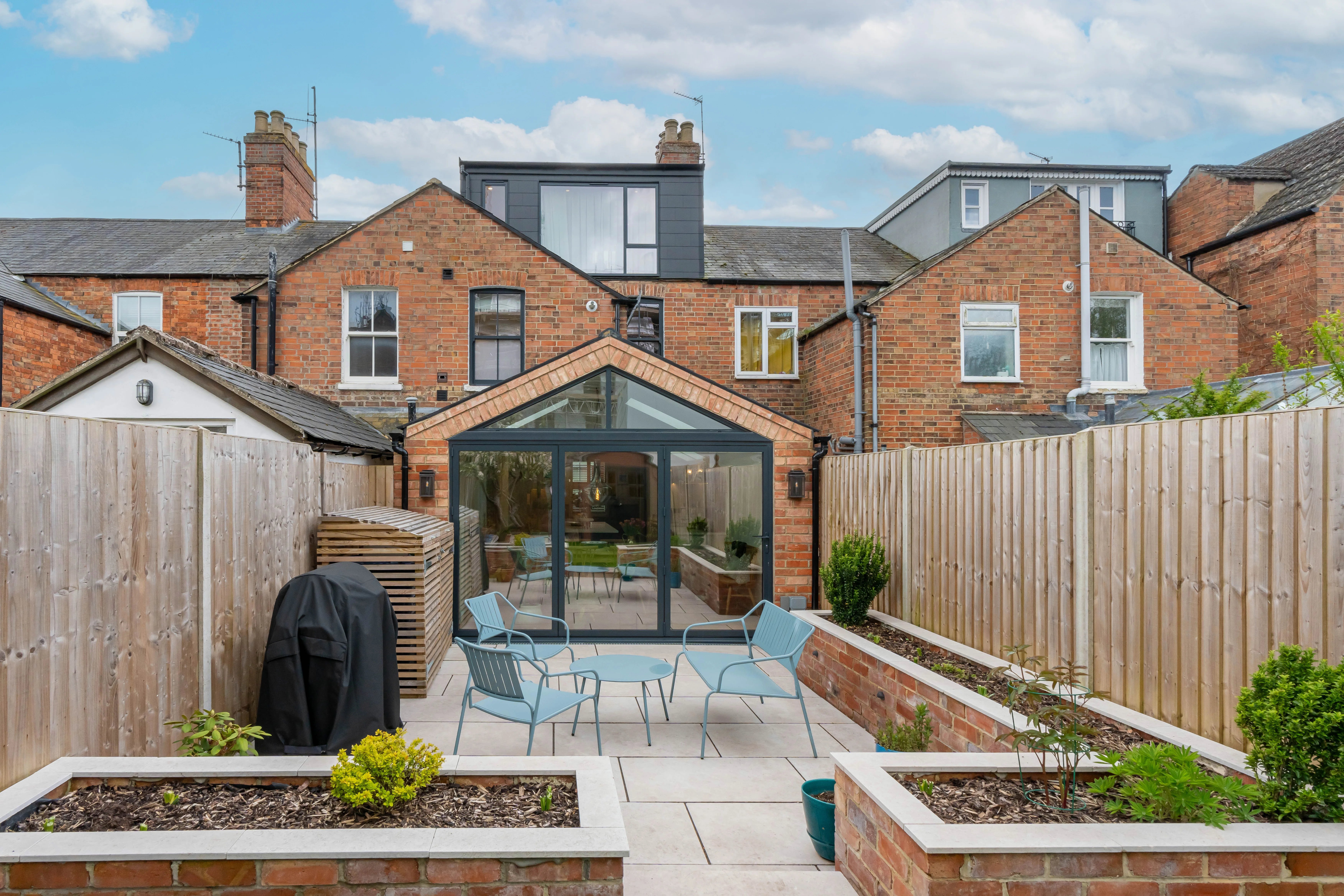 Rooftop terrace with plants and skyline view, showcasing outdoor living space
