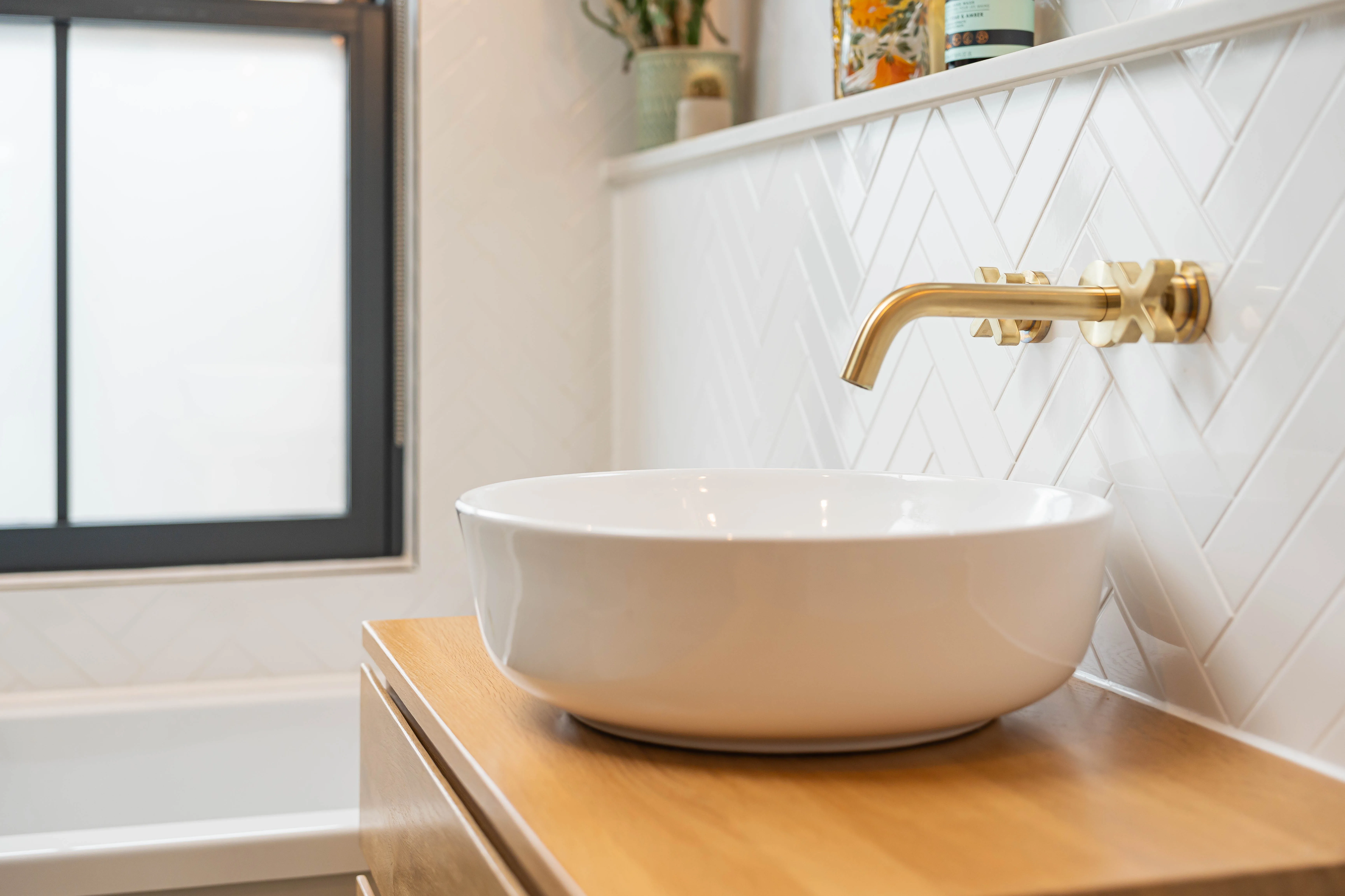 Elegant bathroom sink installation with modern faucet and wooden cabinetry