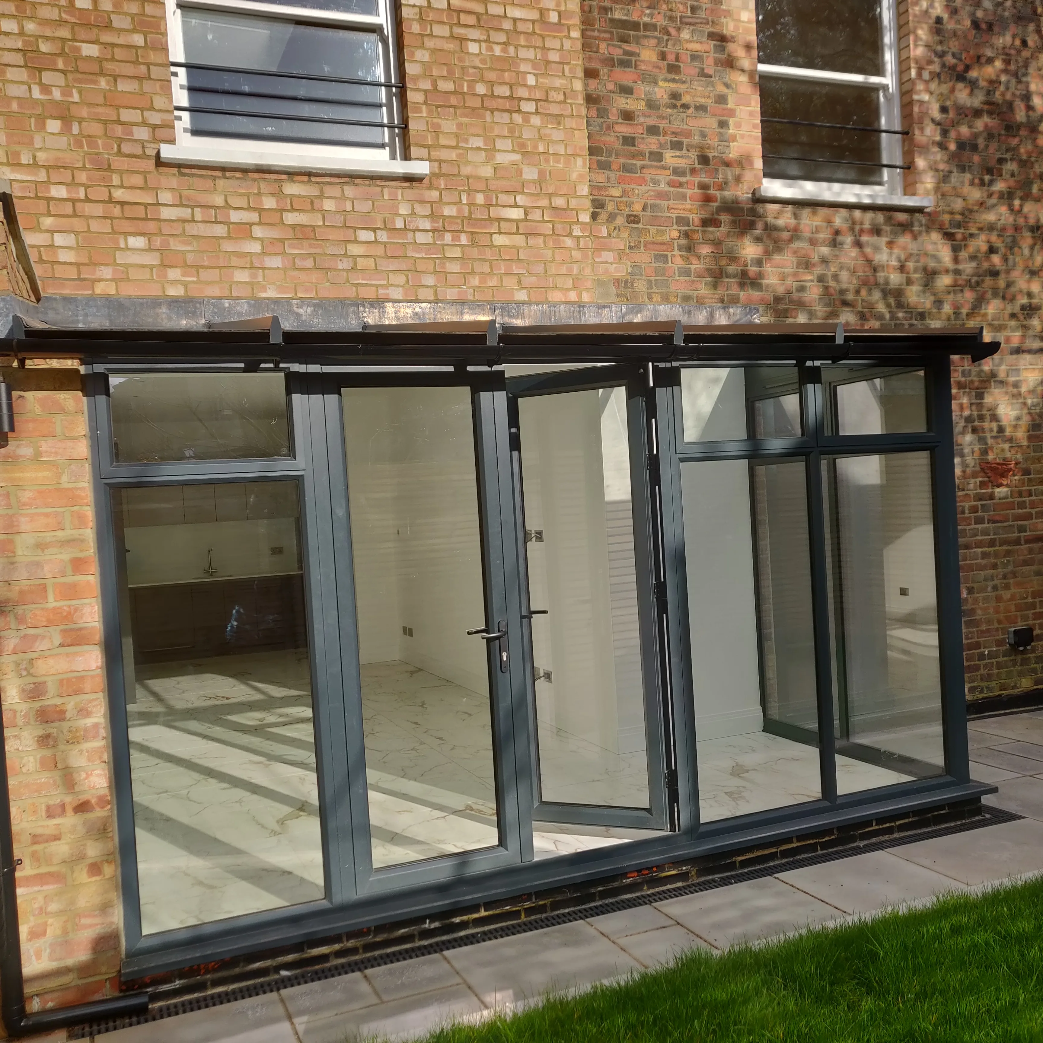 Modern glass extension at the back of a house showcasing a spacious interior