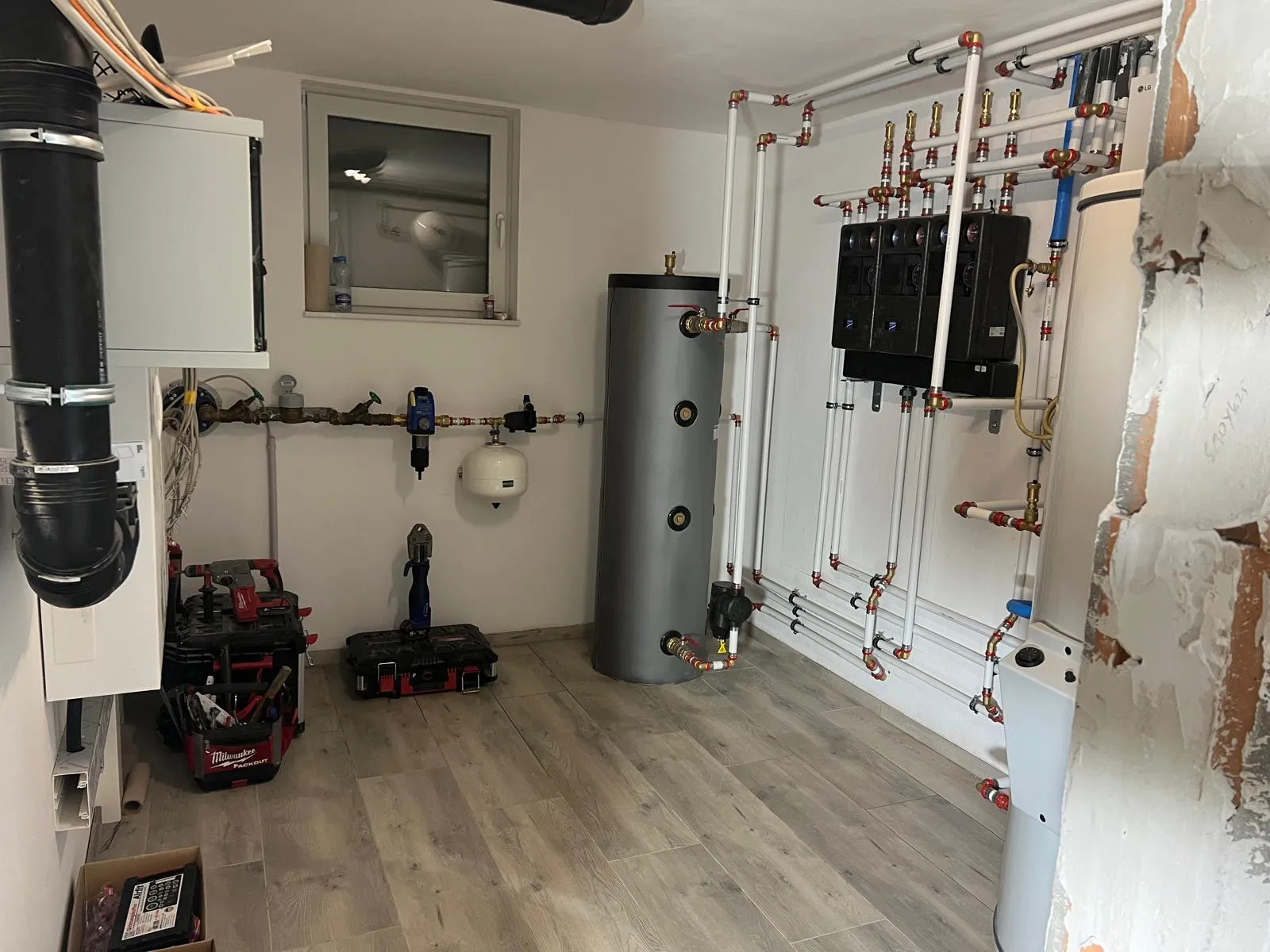 Installed plumbing system with water heater and connections in a home refurbishment project