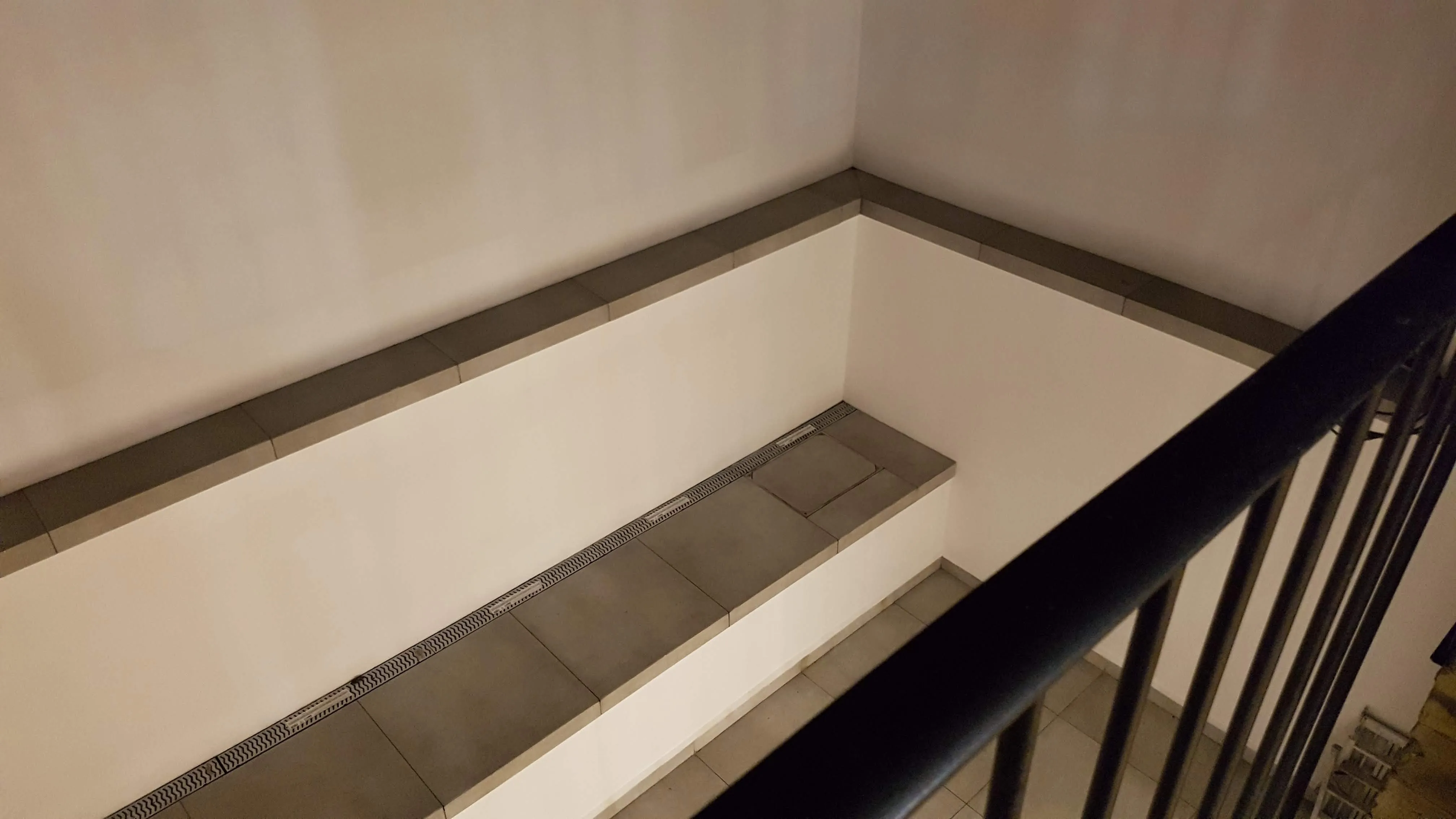 Indoor view of a modern bathroom refurbishment with tiled flooring and sleek wall finishes