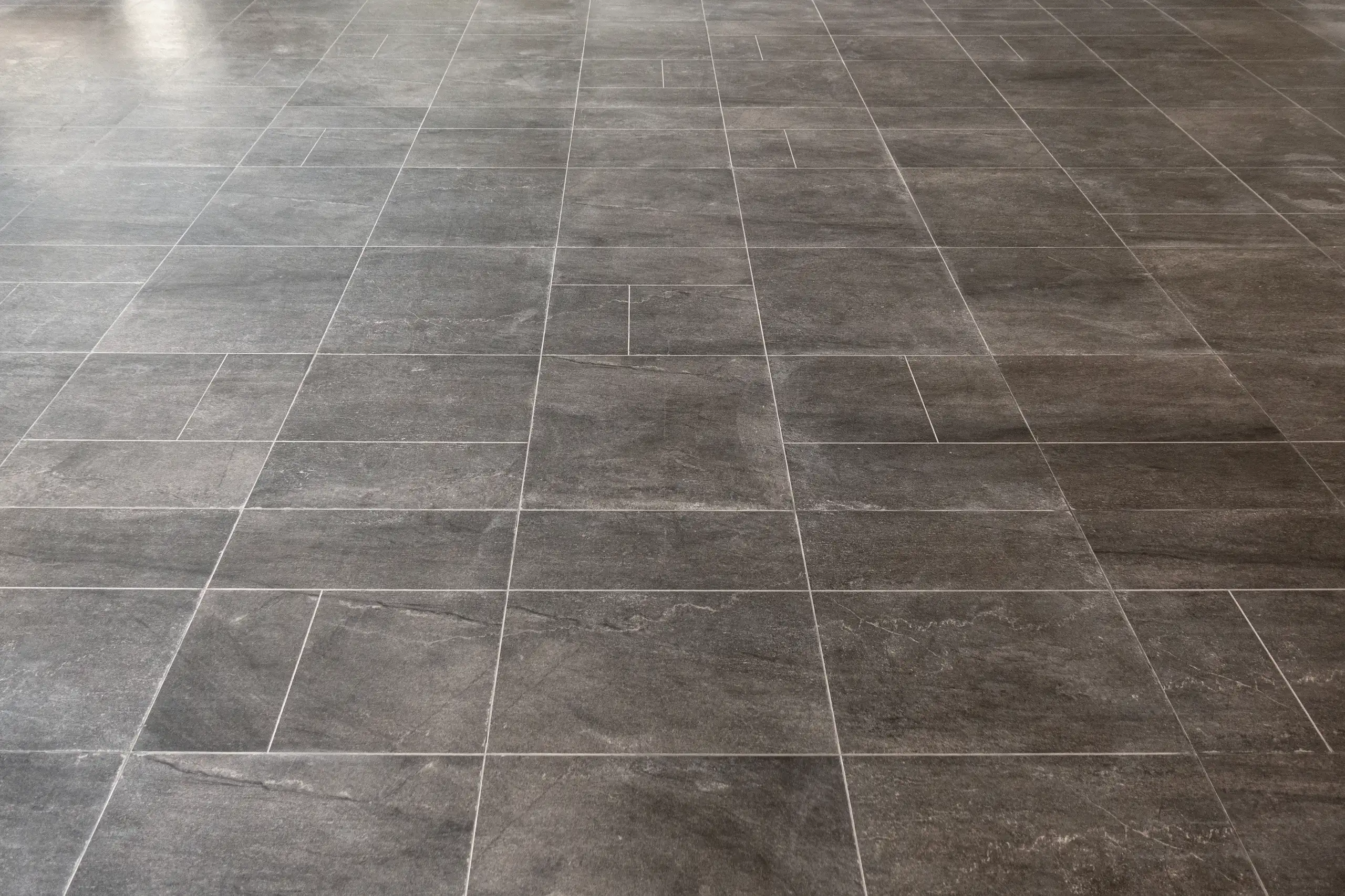 Close-up of grey tile flooring showcasing a modern finish in a home refurbishment project