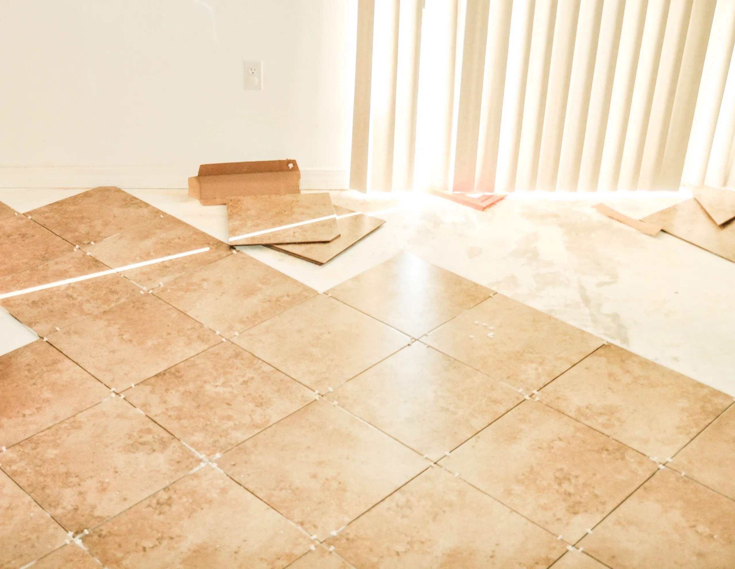 Floor installation in progress, showcasing tile flooring with natural light